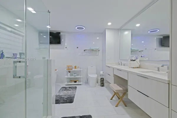 a bathroom with a sink double vanity and shower