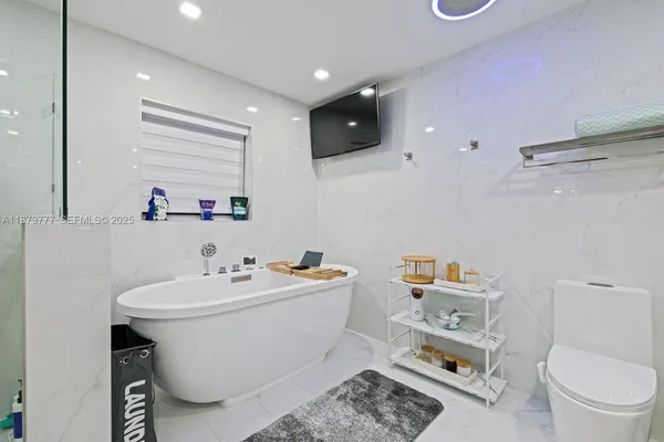 a bathroom with a sink toilet and a mirror