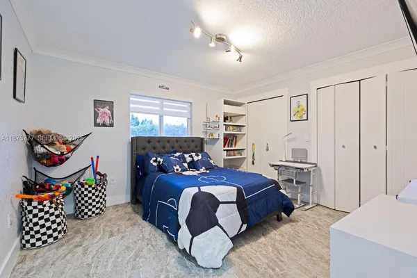 a bedroom with a bed and a lamp