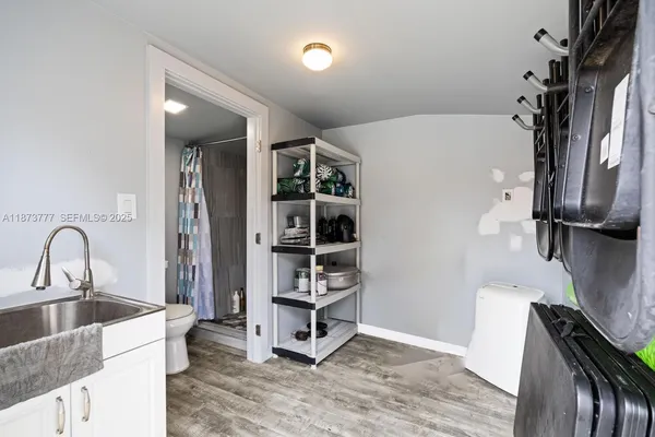 a view of swimming pool with lawn chairs and large trees