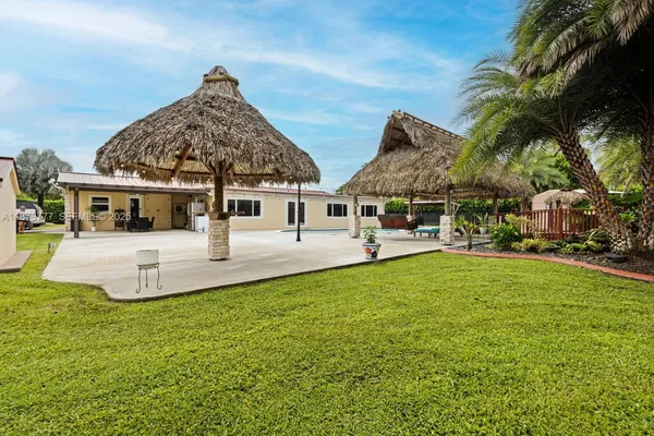 a view of backyard with palm trees