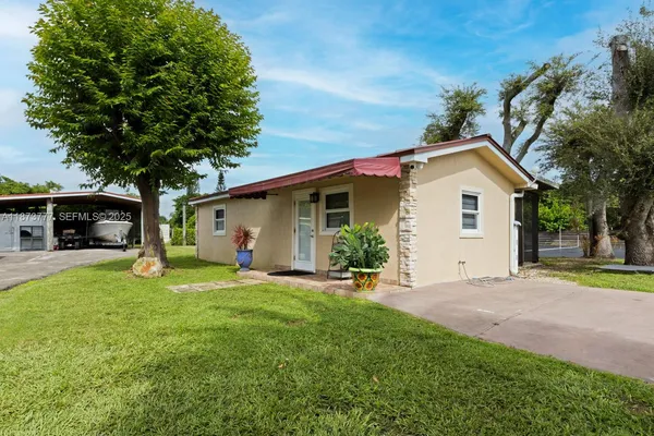 a kitchen with kitchen island a white counter top space cabinets and stainless steel appliances