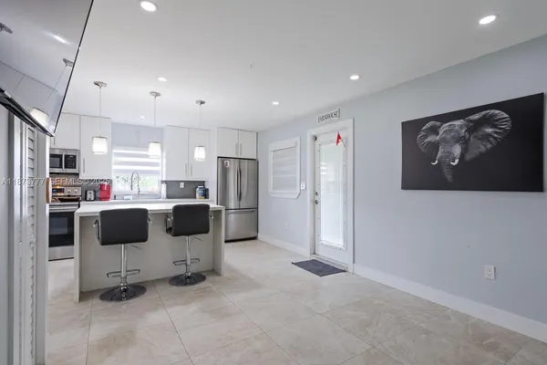 a bedroom with a bed cabinets and window