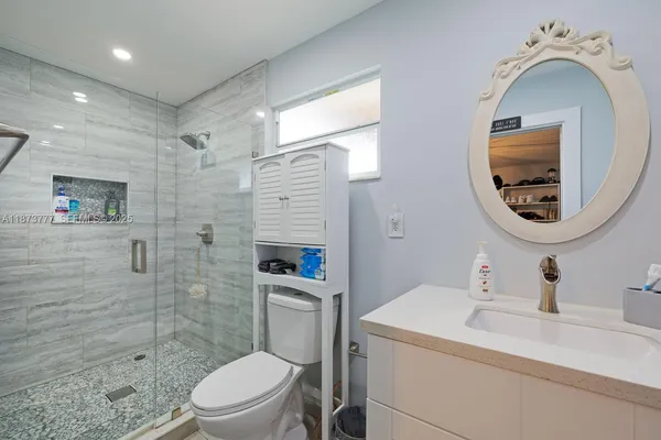 a view of a patio with a table and chairs under an umbrella