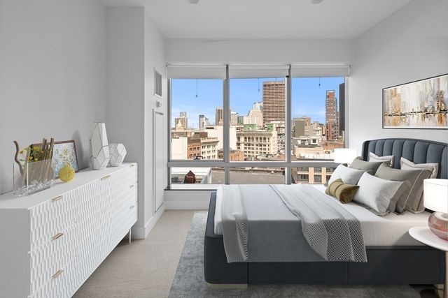 a room with a bed and a large window