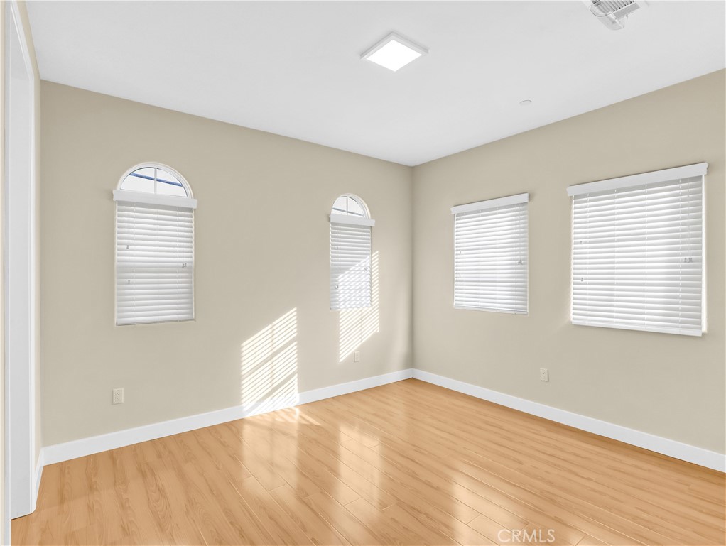 723 South Stoneman Avenue Alhambra, CA 91801 - Photo 8 of 11 a view of an empty room with wooden floor and a window