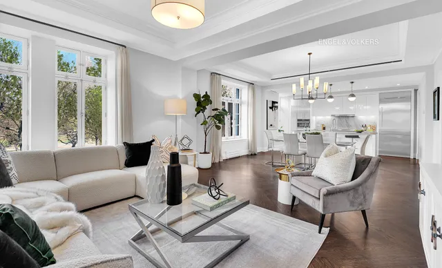 a living room with furniture and a chandelier
