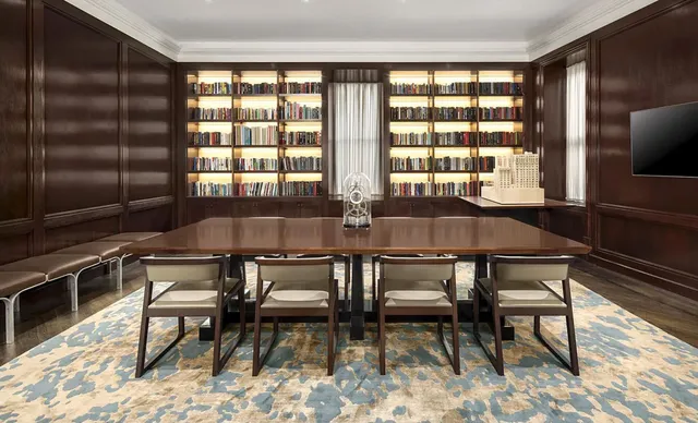 a living room with furniture and a book shelf