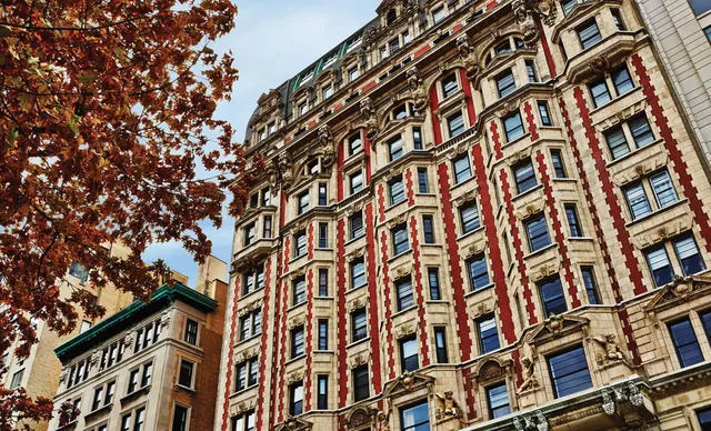 a living room with furniture a flat screen tv and kitchen view