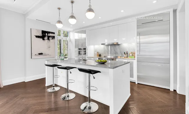 a hallway with sink mirror and cabinets