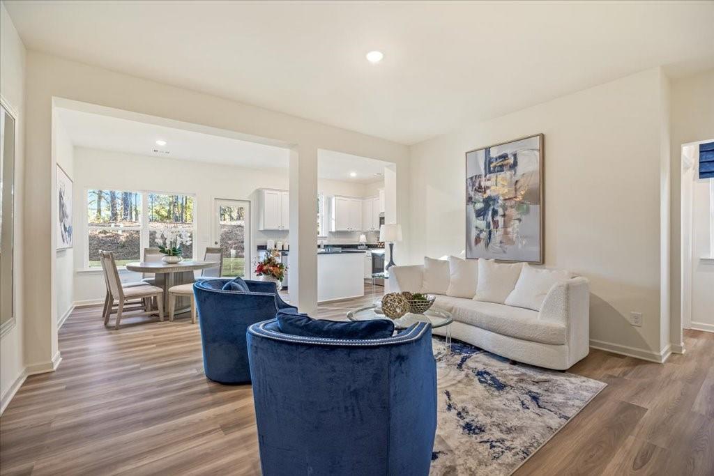 a living room with furniture or couch and a wooden floor