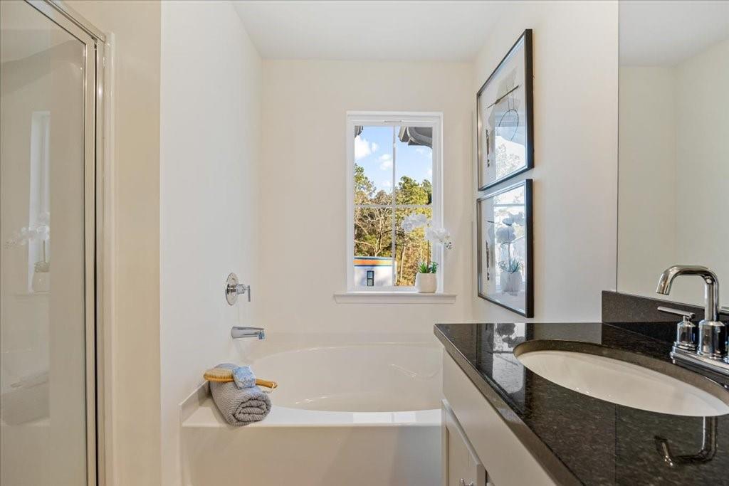 1833 Dawn Road, Unit 22 Conyers, GA 30013 - Photo 22 of 37 a bathroom with a tub sink and mirror