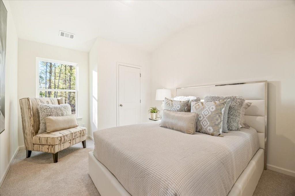 1833 Dawn Road, Unit 22 Conyers, GA 30013 - Photo 23 of 37 a bedroom with a bed and a couch