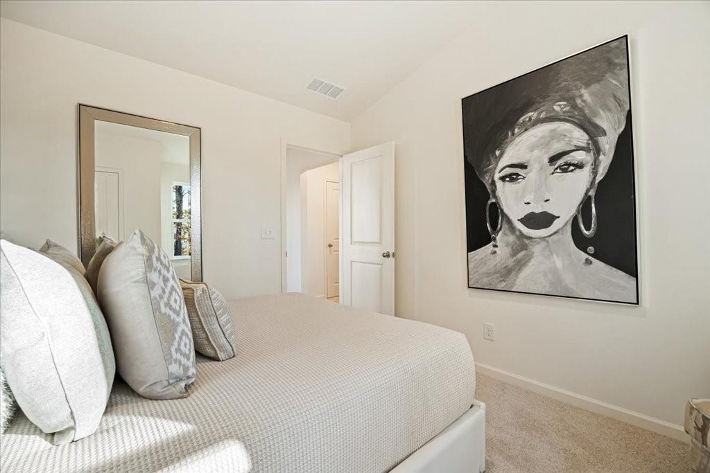 1833 Dawn Road, Unit 22 Conyers, GA 30013 - Photo 24 of 37 a bedroom with a bed and painting on the wall