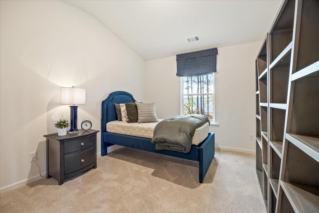 1833 Dawn Road, Unit 22 Conyers, GA 30013 - Photo 25 of 37 a bedroom with a bed flat screen tv and window