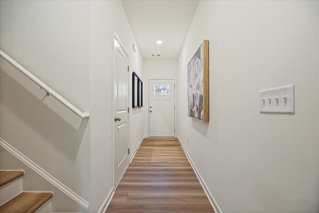 1833 Dawn Road, Unit 22 Conyers, GA 30013 - Photo 4 of 37 a view of a hallway with a white walls and wooden floor
