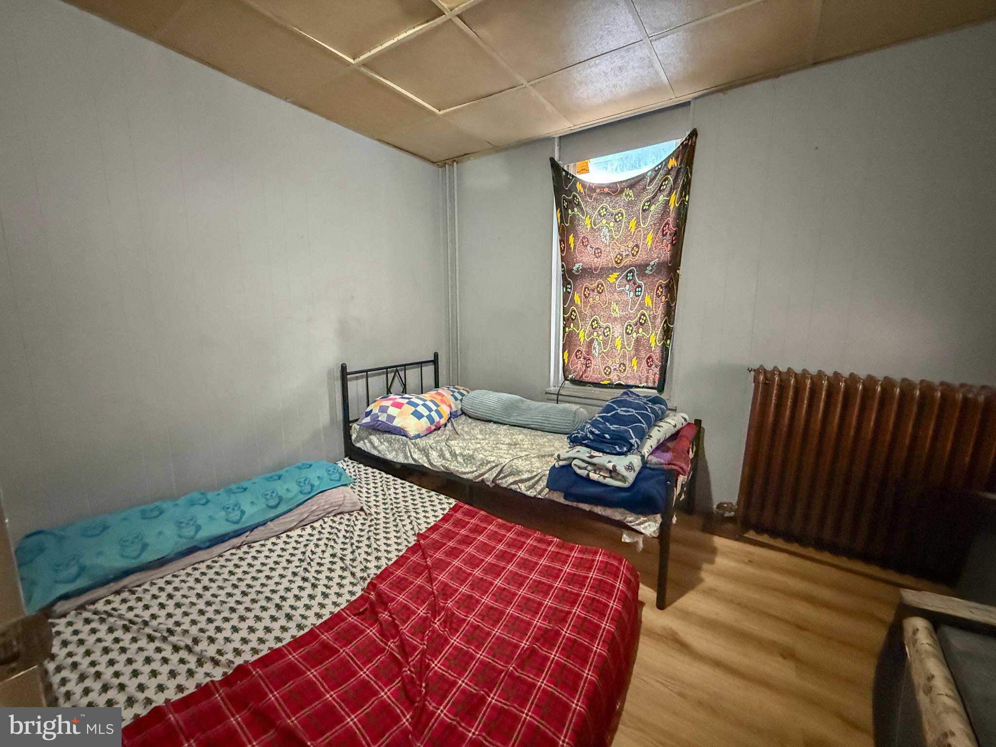 114 North 10th Street Reading, PA 19601 - Photo 24 of 43 a bedroom with a bed and wooden floor