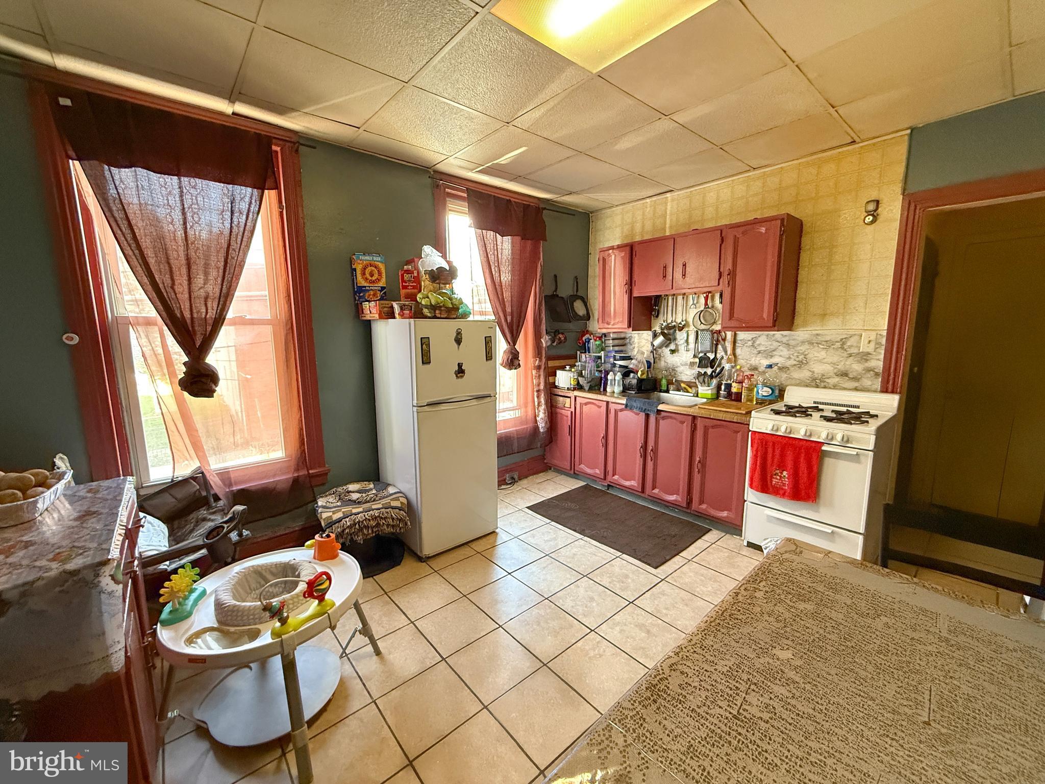 114 North 10th Street Reading, PA 19601 - Photo 30 of 43 a kitchen with sink refrigerator and cabinets