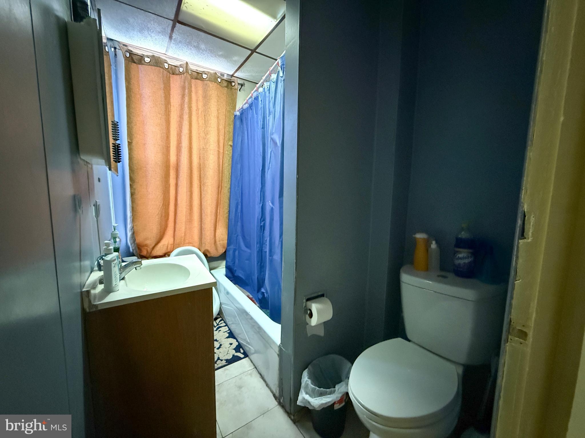 114 North 10th Street Reading, PA 19601 - Photo 31 of 43 a bathroom with a toilet a sink and a mirror