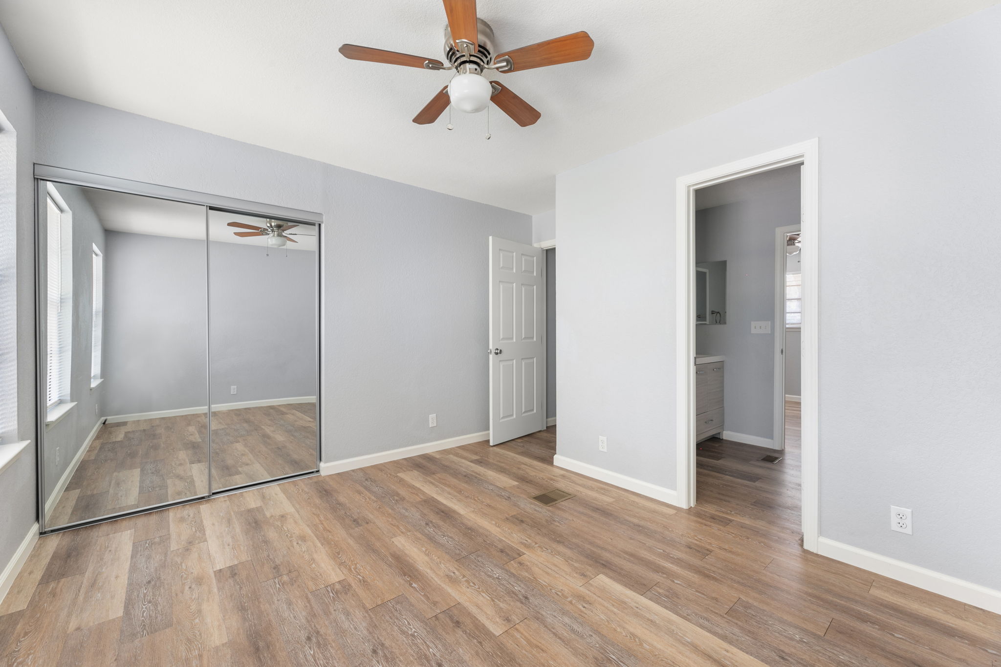 3802 Foust Trail, Unit A Georgetown, TX 78628 - Photo 30 of 34 A comfortable bedroom with rich wood flooring and a refreshing ceiling fan.