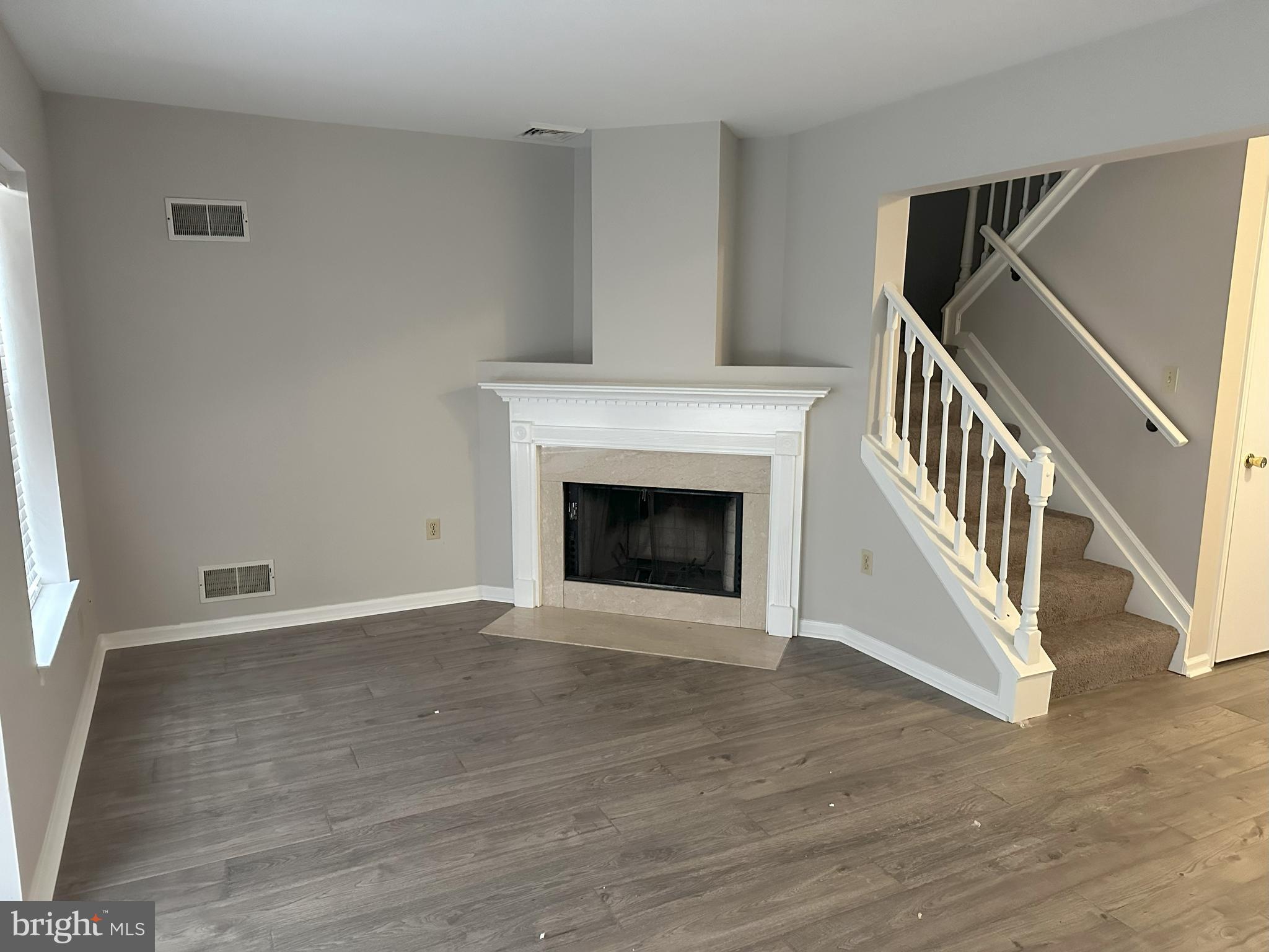 132 Delancy Place Lancaster, PA 17601 - Photo 2 of 14 a view of an empty room with wooden floor fireplace and a window