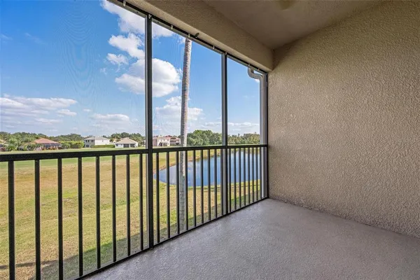 an aerial view of a house with outdoor space and lake view in back
