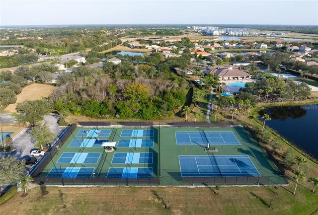 an aerial view of a house having patio with swimming pool