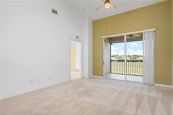 a view of a livingroom with a ceiling fan and window
