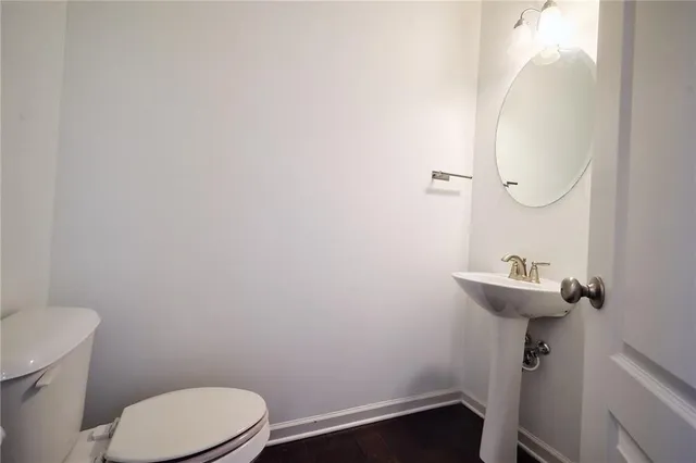 a view of a bathroom with a wooden floor