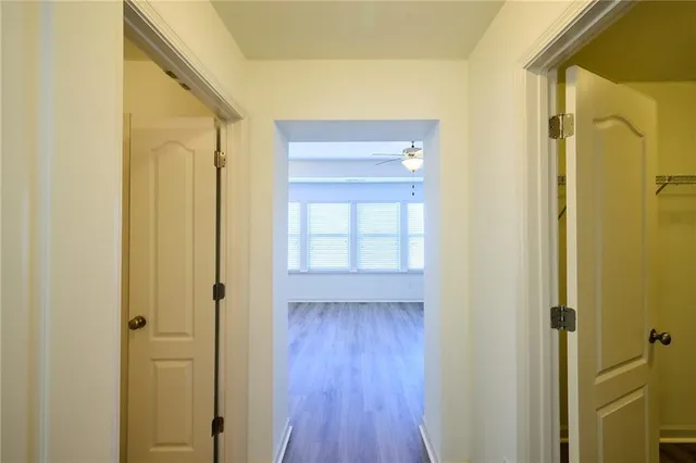 a view of empty room with wooden floor