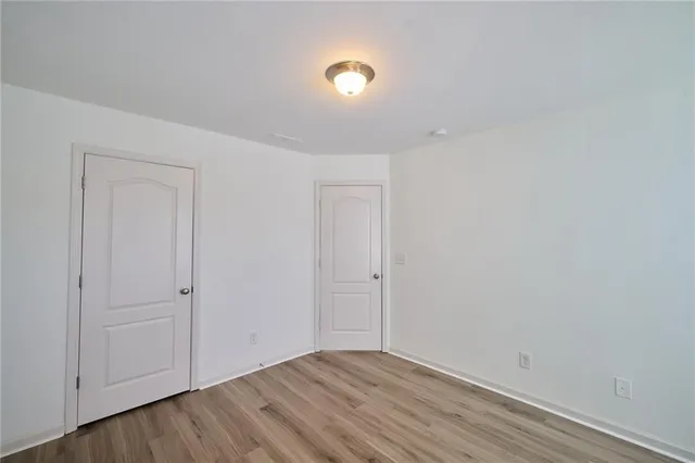 an empty room with a empty space and windows