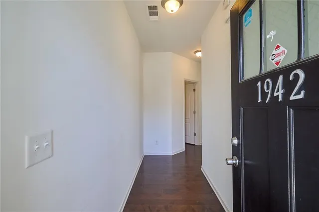 a large open kitchen with a refrigerator a stove cabinets and a dining table