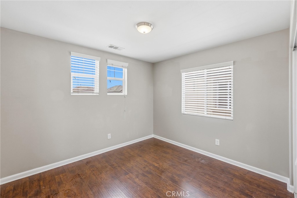 956 West Tibbot Street Rialto, CA 92377 - Photo 36 of 37 a view of an empty room with wooden floor and a window