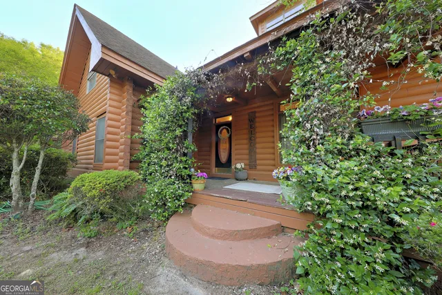 a living room with furniture a flat screen tv and a large window