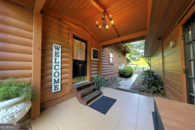 a open kitchen with stainless steel appliances granite countertop a stove a refrigerator a dining table and chairs with wooden floor