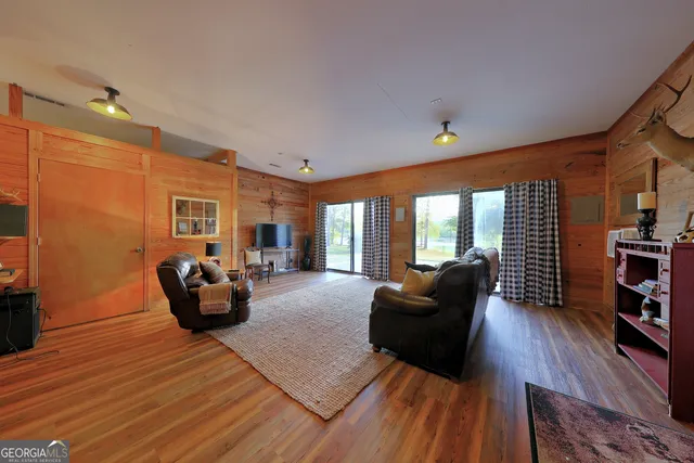 a view of a kitchen with refrigerator and wooden floor