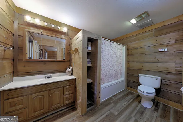 a bedroom with bed and flat screen tv