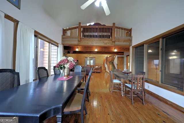 a view of a hallway with windows and wooden floor