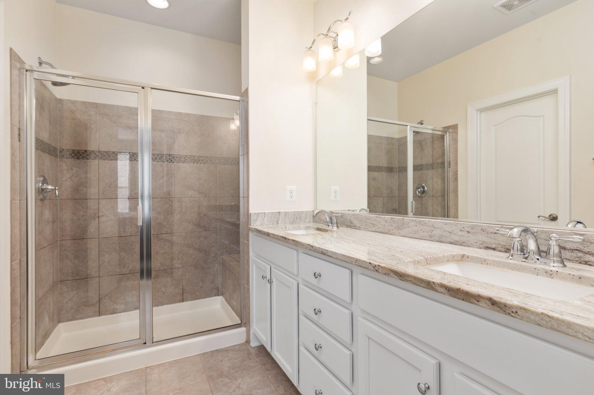 46073 Hall Road Sterling, VA 20166 - Photo 22 of 31 Owners bathroom with dual vanity, stall shower, WC