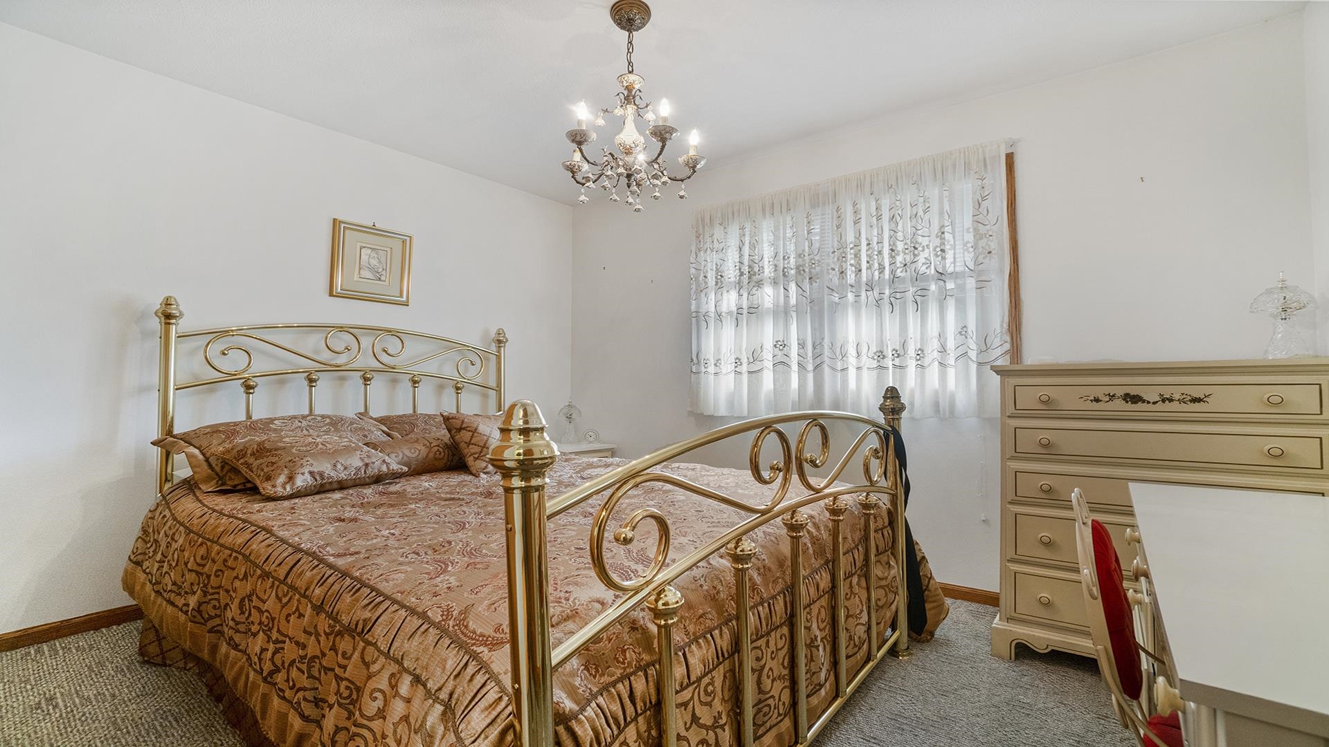 8317 Alan Court Rockford, IL 61108 - Photo 16 of 29 a bedroom with a bed and a chandelier