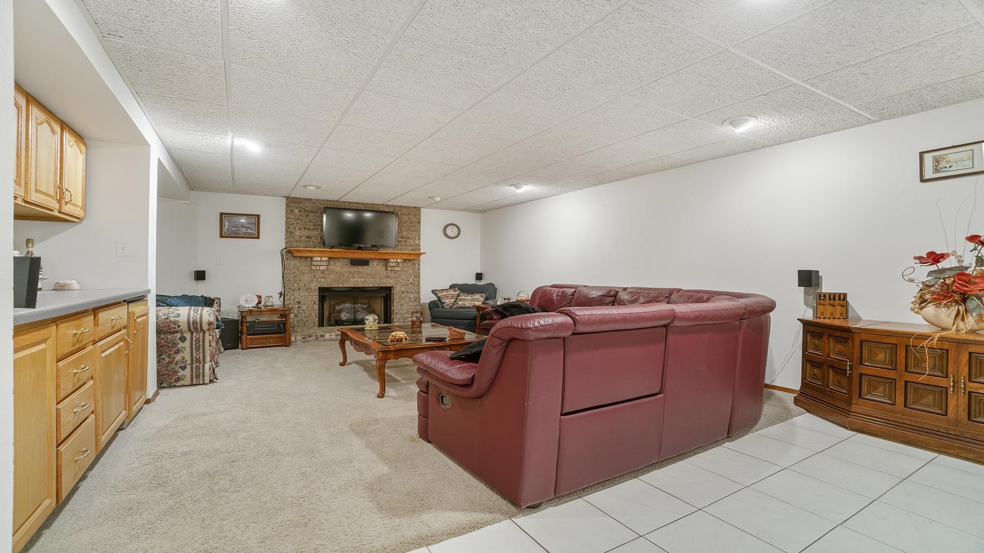 8317 Alan Court Rockford, IL 61108 - Photo 19 of 29 a living room with furniture a fireplace and a refrigerator