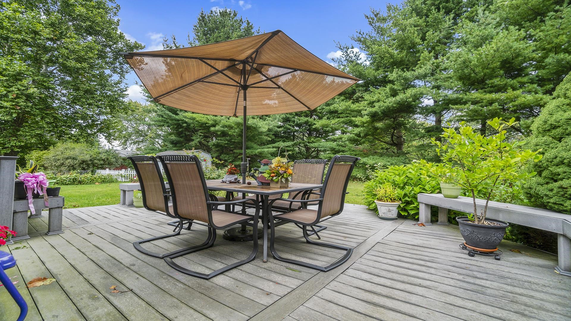 8317 Alan Court Rockford, IL 61108 - Photo 26 of 29 a view of a roof deck with table and chairs under an umbrella
