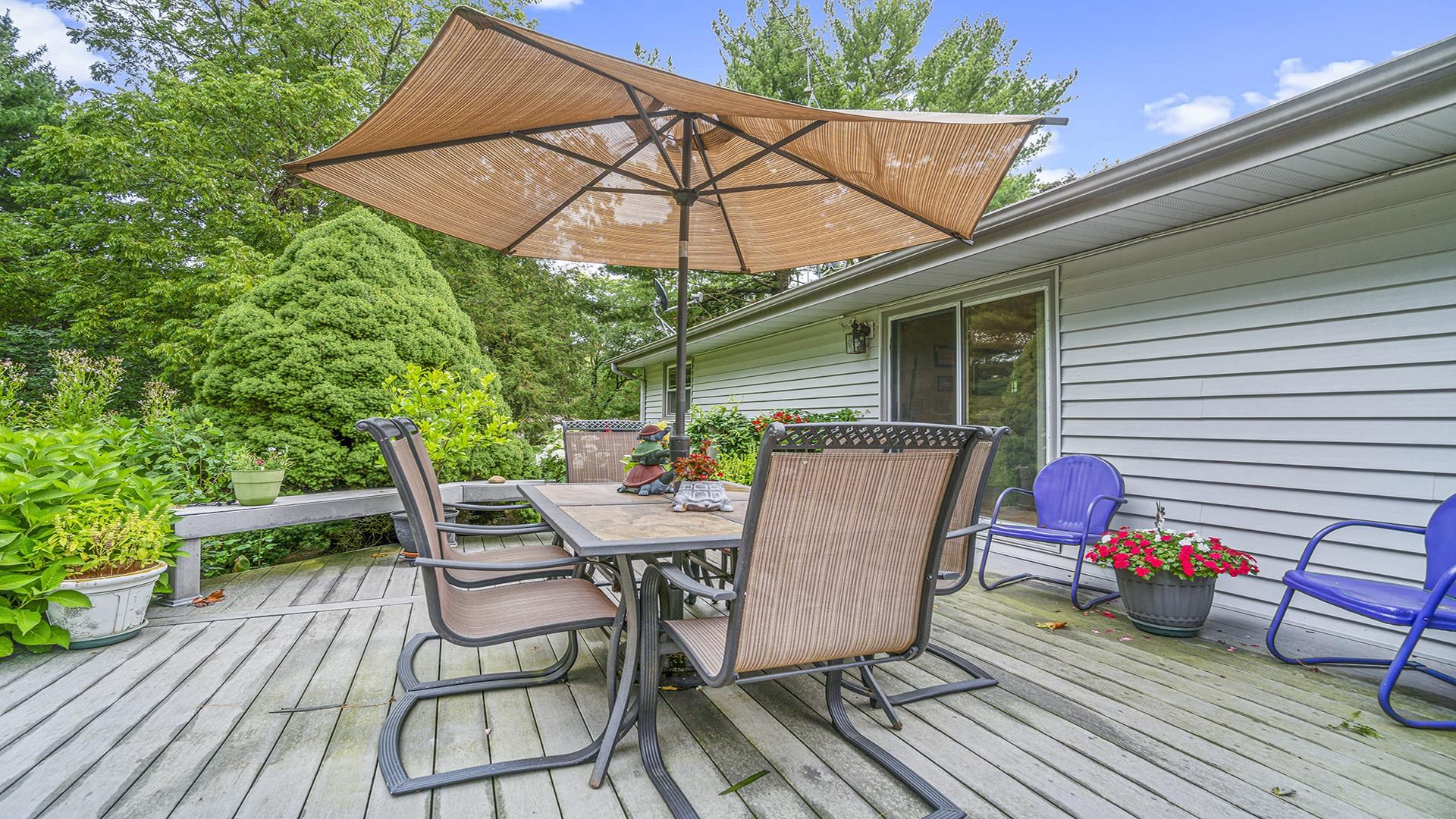 8317 Alan Court Rockford, IL 61108 - Photo 27 of 29 a view of a roof deck with table and chairs under an umbrella