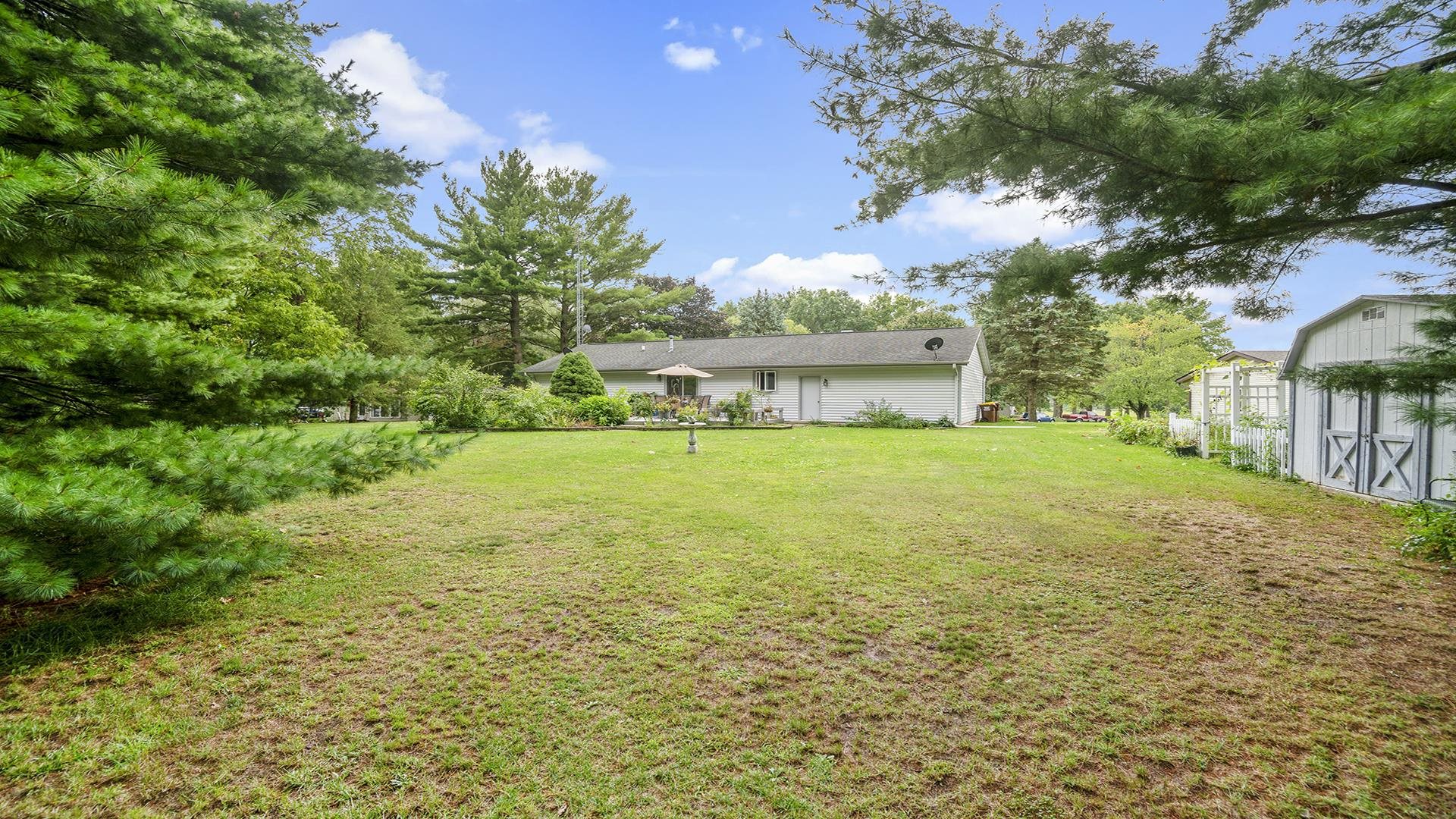 8317 Alan Court Rockford, IL 61108 - Photo 28 of 29 a view of a yard with plants and large trees