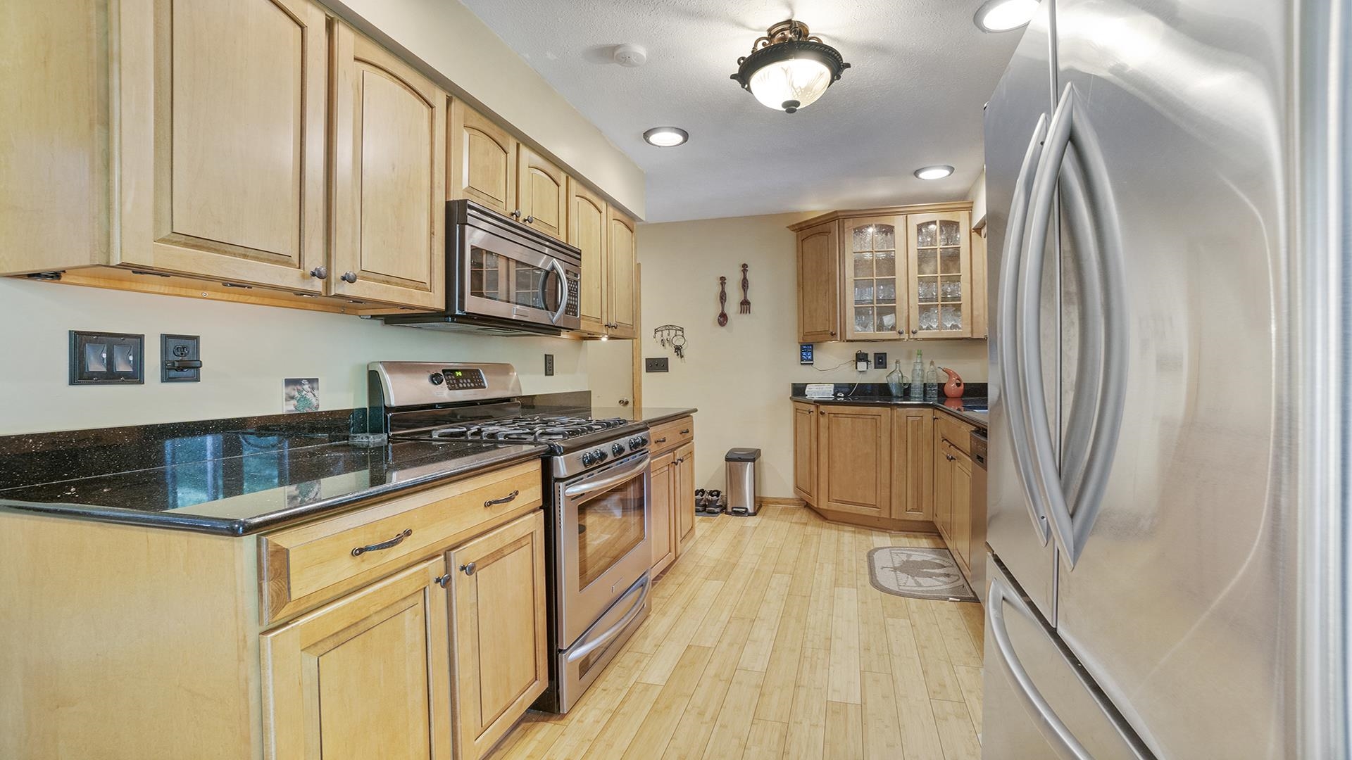 8317 Alan Court Rockford, IL 61108 - Photo 10 of 29 a kitchen with stainless steel appliances granite countertop a stove a sink and a refrigerator