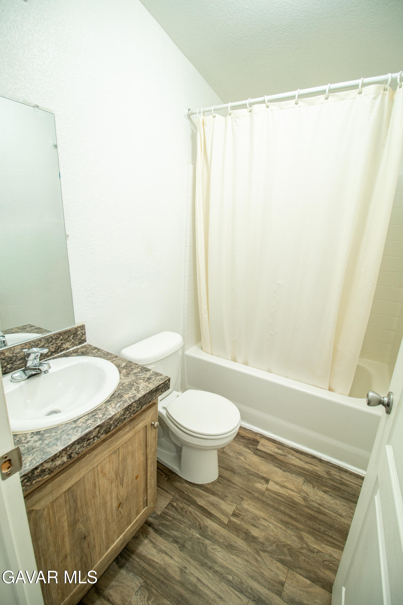 4444 Avenue R Palmdale, CA 93552 - Photo 14 of 17 a bathroom with a granite countertop sink toilet and shower