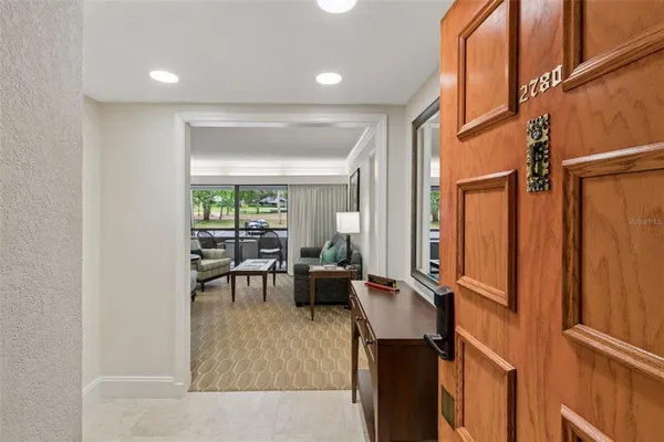 a kitchen with stainless steel appliances granite countertop a refrigerator a sink a stove and a refrigerator