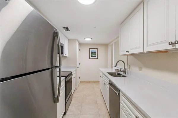a kitchen that has a sink and a stove