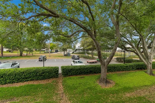 a view of a backyard with sitting area and garden