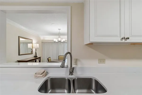a kitchen with stainless steel appliances granite countertop a sink and a stove